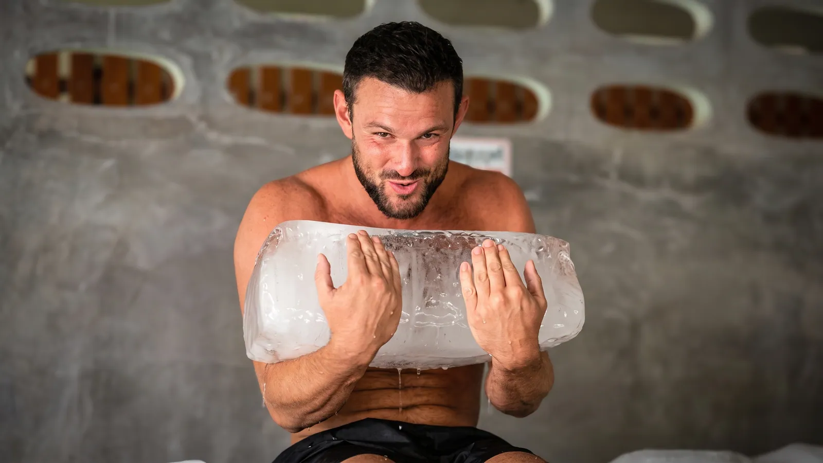 A Prime Revive guest holding a block of ice during a recovery session in Phuket