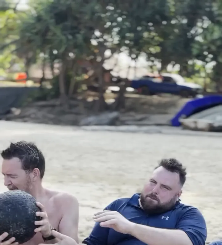 Connor with a medicine ball during a coached beach workout in Phuket